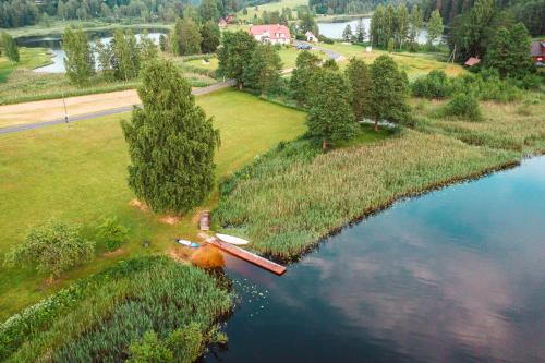 an aerial view of a river with trees and grass at ÖÖD Hötels Rõuge in Rouge