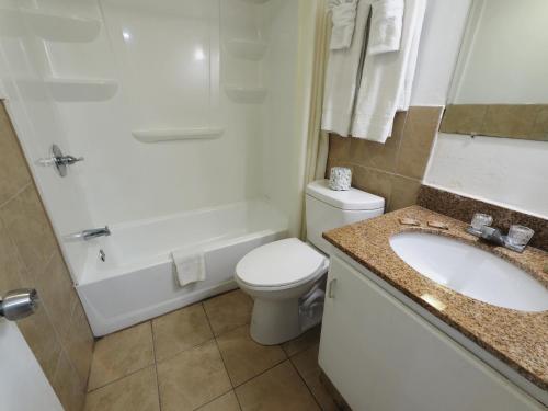 a bathroom with a sink and a toilet and a shower at White Marlin Inn - Virginia Beach in Virginia Beach