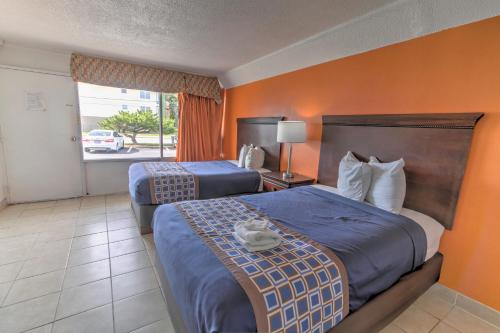 a hotel room with two beds and a window at White Marlin Inn - Virginia Beach in Virginia Beach