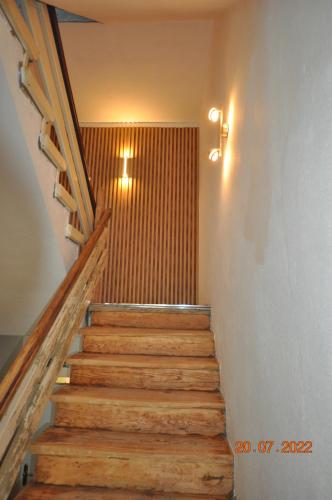 a staircase with wooden steps in a building at Parkhotel Schwedt in Schwedt