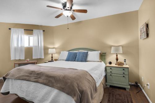 a bedroom with a bed and a ceiling fan at Holiday Surf and Racquet Club 412 in Destin