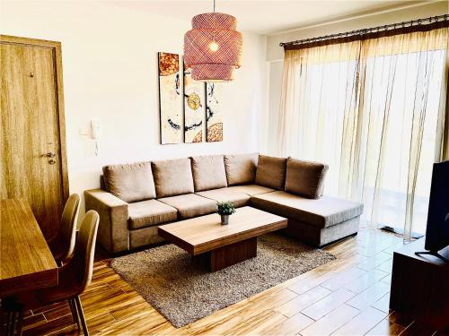 a living room with a couch and a coffee table at BALI SUITES 303 in Larnaka