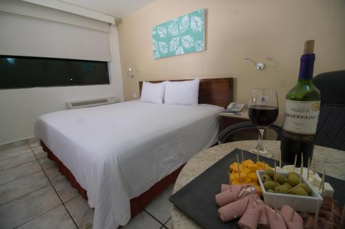 Cama ou camas em um quarto em Olmeca Plaza Urban Express