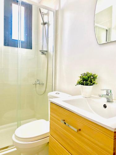 a bathroom with a sink and a toilet and a shower at BALI SUITES 505 in Larnaca
