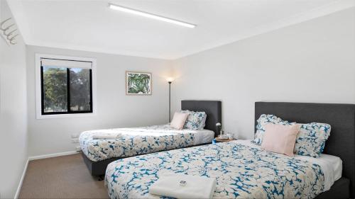1 dormitorio con 2 camas y ventana en Sutton Forest Retreat Jimmys Homestead, en Sutton Forest