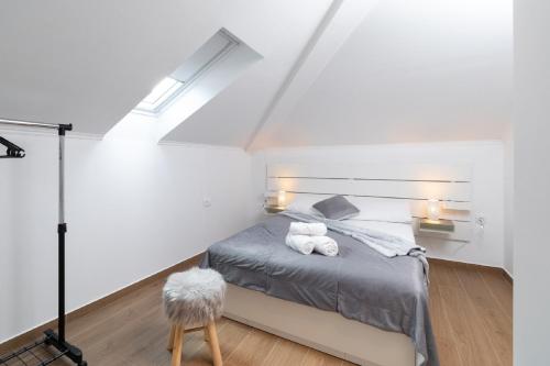 a bedroom with a bed with two towels on it at Apartment Dragojevic in Vela Luka