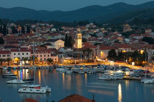 a harbor with boats in a town at night at Apartment Dragojevic in Vela Luka