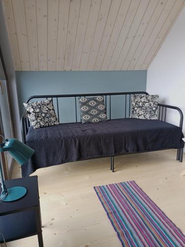 a bed in a room with a ceiling at Chutor Grzegorza in Wysowa-Zdrój