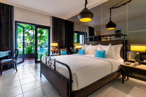 A bed or beds in a room at Shinta Mani Angkor & Bensley Collection Pool Villas