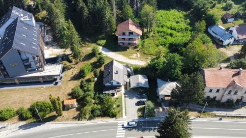 an aerial view of a house with a road and houses at Apartment Bobic in Ličko Petrovo Selo