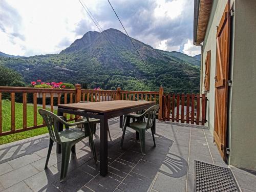 d'une table et de chaises sur un balcon avec vue sur la montagne. dans l'établissement Maison de montagne proche Gavarnie 12-14 personnes, à Gèdre