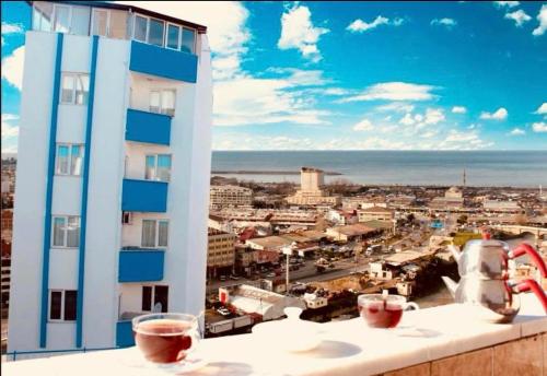 a building with two glasses of wine on a ledge at Kuzey suite home in Trabzon