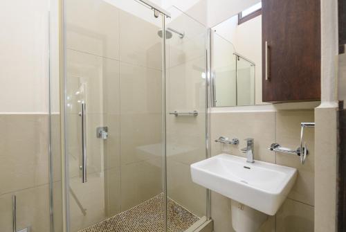 a bathroom with a sink and a glass shower at San Lameer Villa 3126 - 3 Bedroom Superior - 6 pax - San Lameer Rental Agency in Southbroom