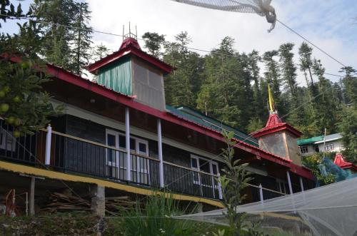 a building with a red roof and two turrets at Hari Om Paradise in Kūfrī