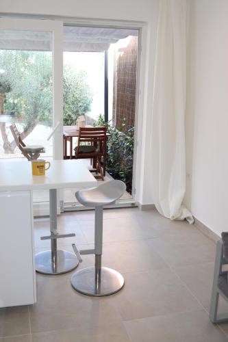 a white table and chairs in a room with a window at Lovely Suite in Šibenik