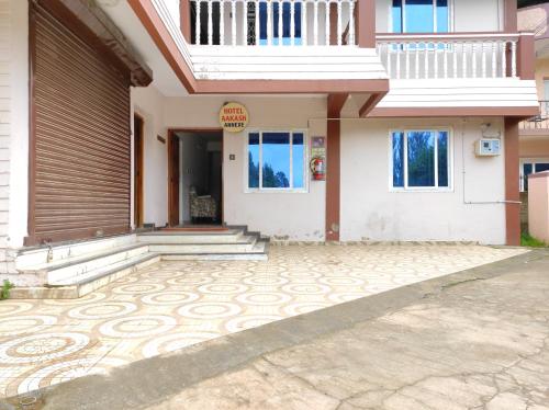 a house with a tiled driveway in front of it at Aakash Rooms and Cottages, in Ooty