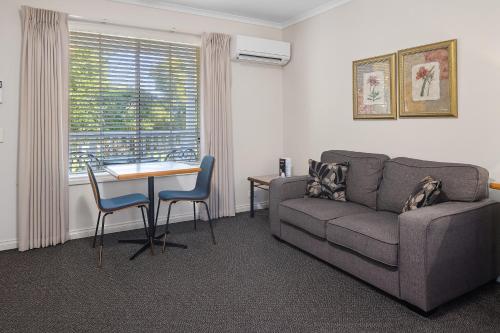 a living room with a couch and a table at Yarra Gables in Healesville