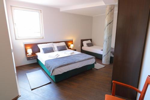 a small bedroom with a bed and a window at Fenix Apartments in Soko Banja