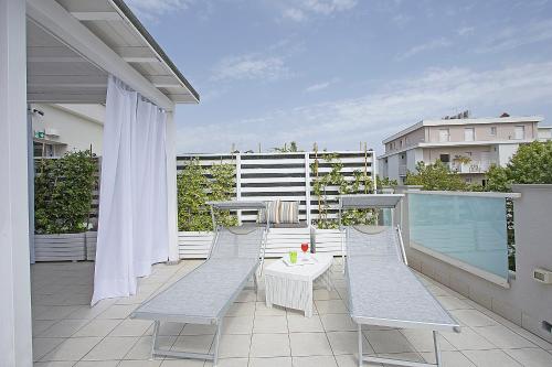 a balcony with two chairs and a table on a building at Residence Armony in Misano Adriatico