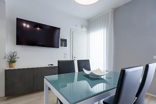 a dining room with a glass table and chairs at Residence Armony in Misano Adriatico
