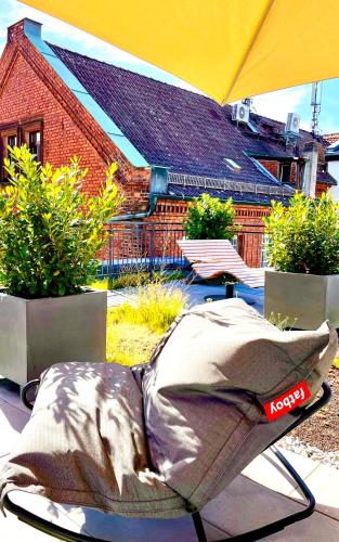 a bed sitting on a patio with an umbrella at zeitwohnhaus SUITE-HOTEL & SERVICED APARTMENTS in Erlangen