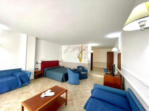 a living room with blue couches and a table at Gli Dei in Pozzuoli
