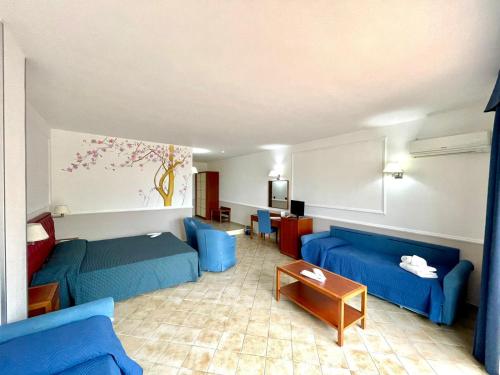 a living room with blue couches and a table at Gli Dei in Pozzuoli