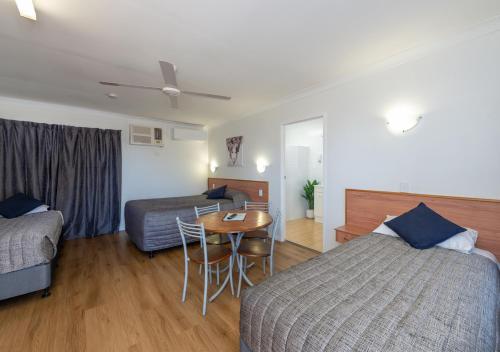 a hotel room with two beds and a table at Riviera on Ruthven in Toowoomba