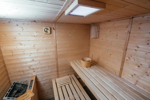 a wooden sauna with a bench in a room at C Guest House in Drobeta-Turnu Severin