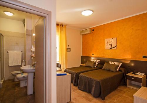 Кровать или кровати в номере Hotel Gabrini