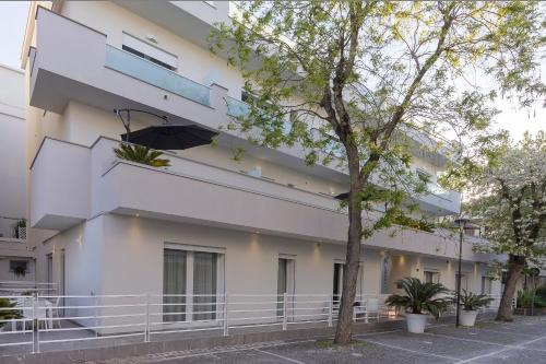 a white building with a staircase on the side of it at Residence Armony in Misano Adriatico