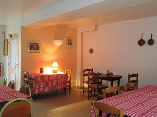 a dining room with two tables and a table and chairs at Maison de 3 chambres avec jardin amenage et wifi a Coulombs en Valois in Mary-sur-Marne