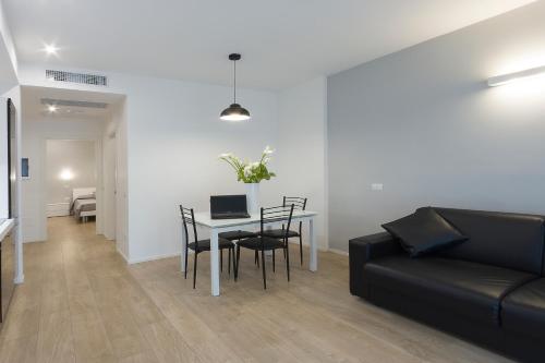 a living room with a couch and a table with chairs at Residence Armony in Misano Adriatico