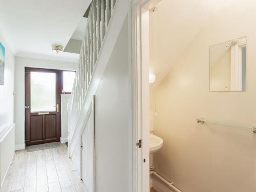 a bathroom with a staircase leading up to a stair case at The Willows in Church Stretton