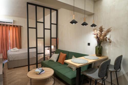 a living room with a green couch and a table at LEO CENTRALE in Kalamata