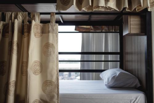 a bedroom with a bunk bed with a window at SLEEP TO FLY HOTEL & HOSTEL suvarnabhumi airport in Bangkok