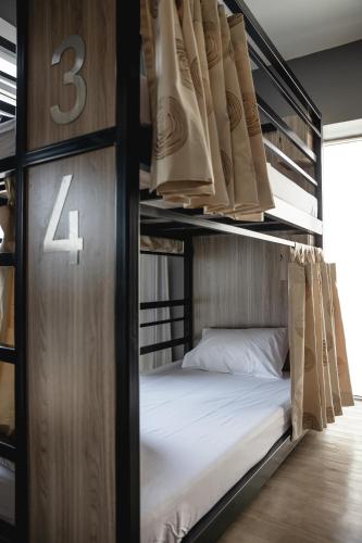a couple of bunk beds with a bed in a room at SLEEP TO FLY HOTEL & HOSTEL suvarnabhumi airport in Bangkok