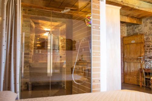 a shower in a room with a glass wall at La Locanda Della Campanara in Santa Sofia