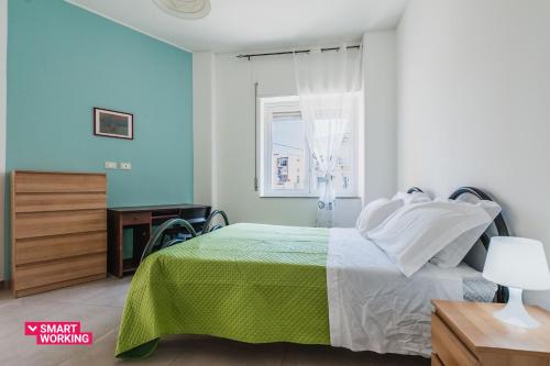 um quarto com uma cama verde e branca e uma janela em Rapisardi 188 Apartment by Wonderful Italy em Catânia