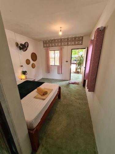 a bedroom with a bed in a room at Phangan Villa Bungalows in Thongsala