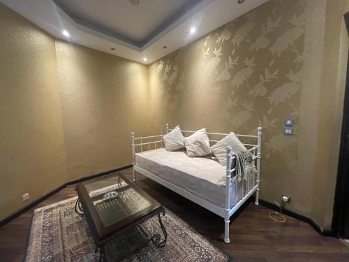 a bedroom with a white bed and a wall with butterflies at Royal Mariout Villa in King Mariout