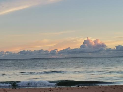 a sunset on the beach with the ocean at Helios Beach Resort in Tangalle
