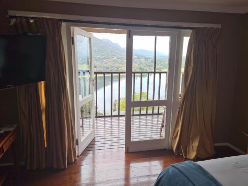 a bedroom with a door open to a balcony at Letamong in Hartbeespoort
