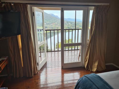 a bedroom with a door open to a balcony at Letamong in Hartbeespoort