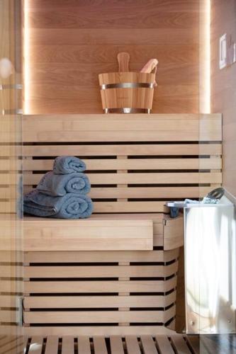 a pile of towels on a shelf in a bathroom at Ni President Suite, DeMaNi President Suites in Sitia