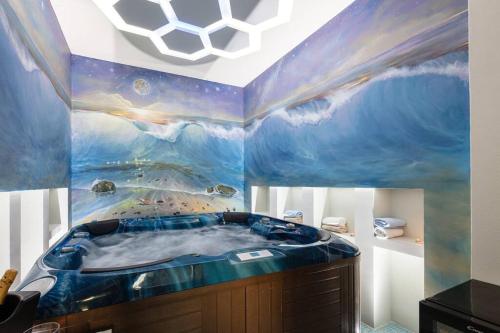 a bathroom with a tub with a painting on the ceiling at Ni President Suite, DeMaNi President Suites in Sitia