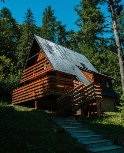 a log cabin with stairs leading up to it at Ośrodek Wczasów Zdrowotnych Rudawka Rymanowska in Rudawka Rymanowska