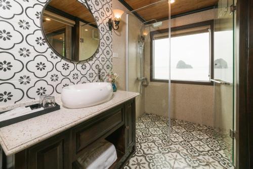 a bathroom with a sink and a mirror at Victory Star Cruise in Ha Long