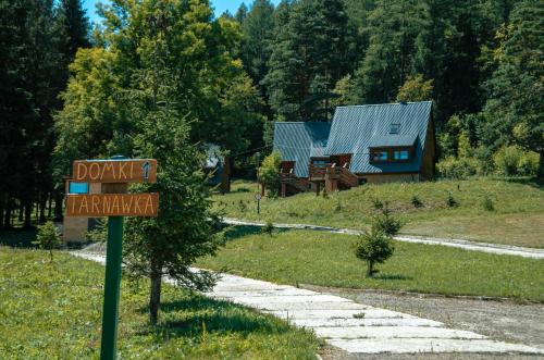a sign in front of a house with a yard at Ośrodek Wczasów Zdrowotnych Rudawka Rymanowska in Rudawka Rymanowska