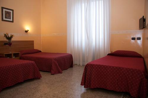 a hotel room with two beds and a window at Casa La Salle - Casa Religiosa in Rome